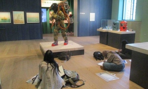 Students sketching a scultpure